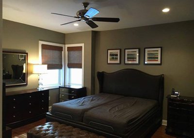 a bedroom with grey painted walls