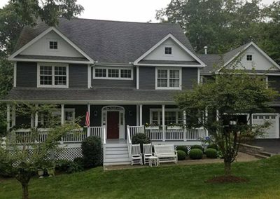 an outdoor front facing view of home with new paint job and white trim