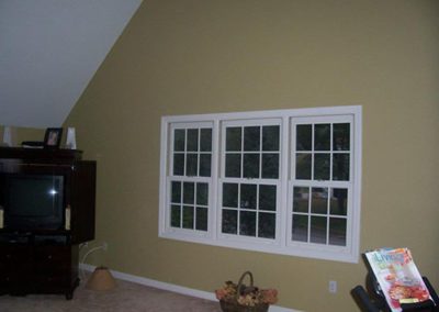 a wall with a window and white trim
