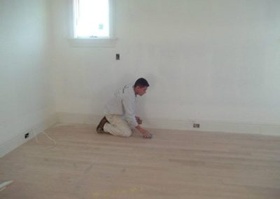 a man sanding a floor