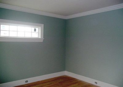 an empty room with blue paint on walls