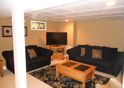 A finished basement, with furniture and new paint