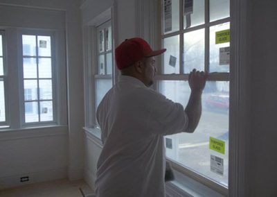 a man painting windows