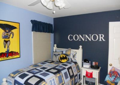 A childs bedroom with a Batman theme